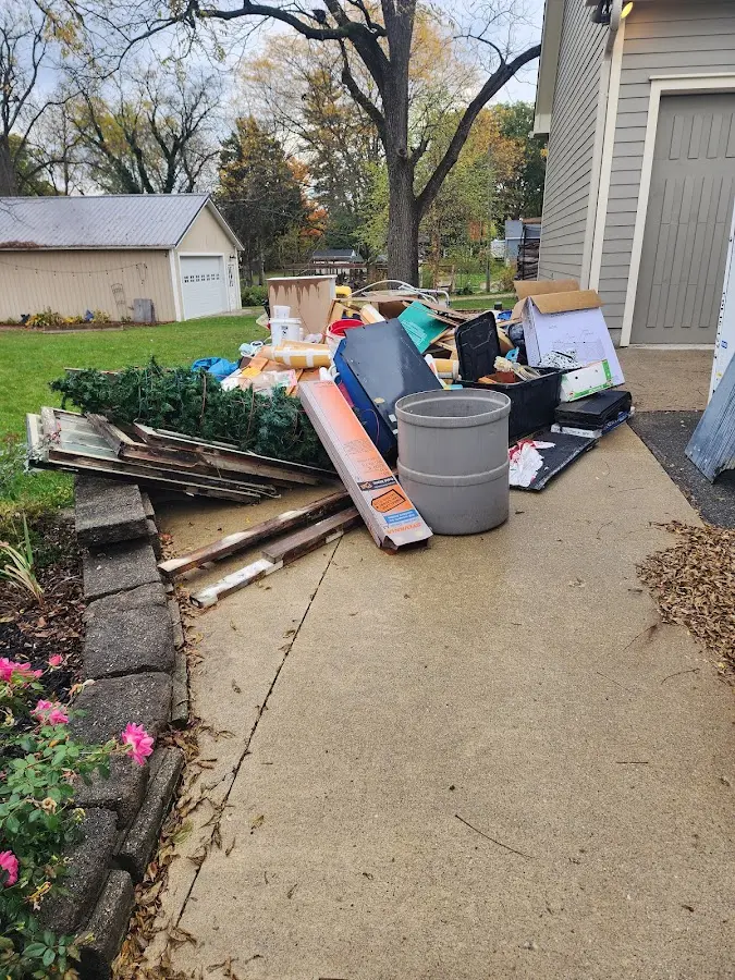 Dumpster being loaded with debris for Estate Cleanout Dumpster Rental in Holden Lakes